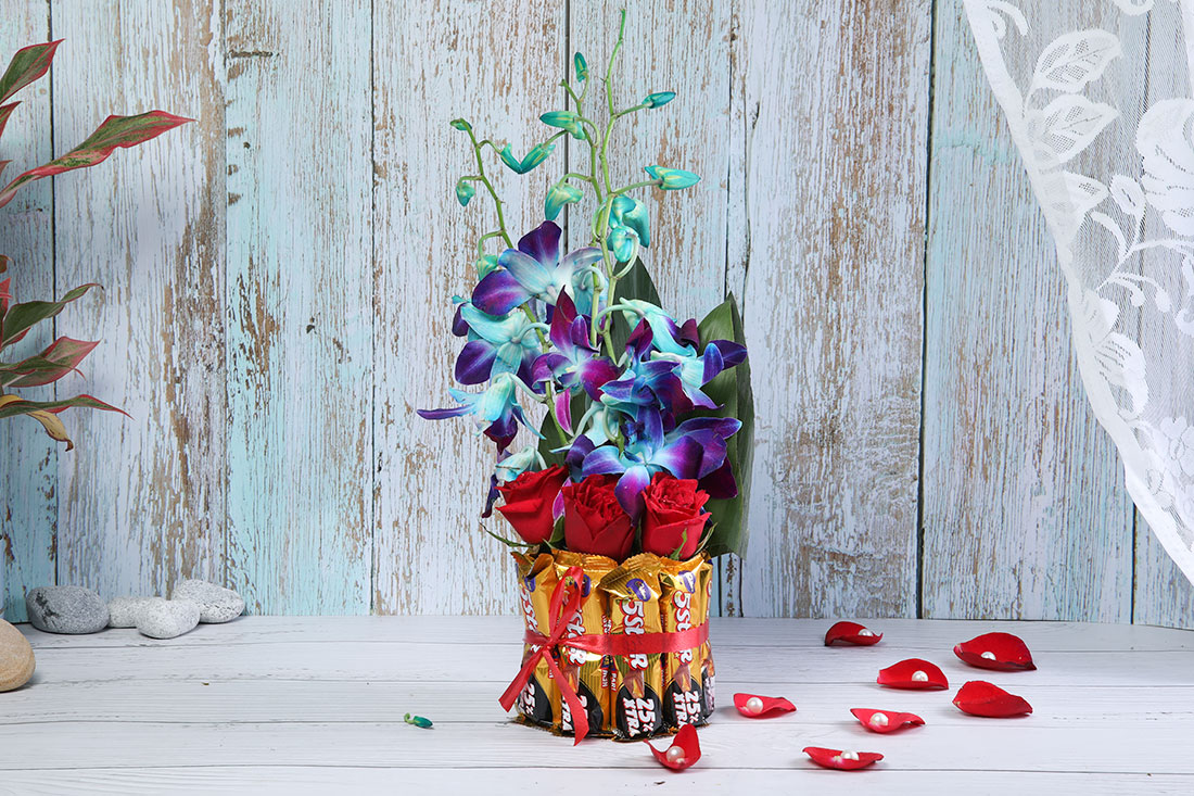 Combo of 4 Red Roses, 3 Blue Orchids and 8 Five Star Chocolates