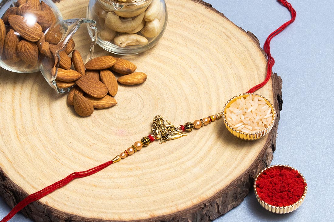 Golden Ganesha Rakhi With Almonds