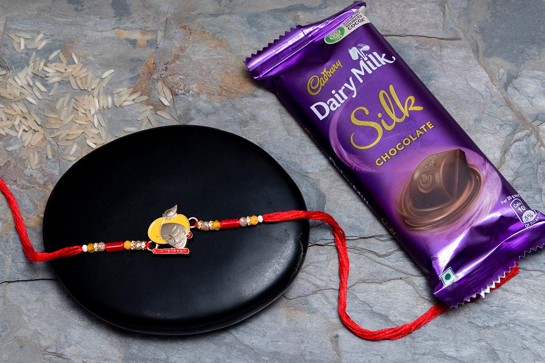 Silver Krishna Rakhi With Dairy Milk