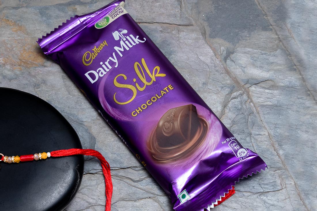 Silver Krishna Rakhi With Dairy Milk